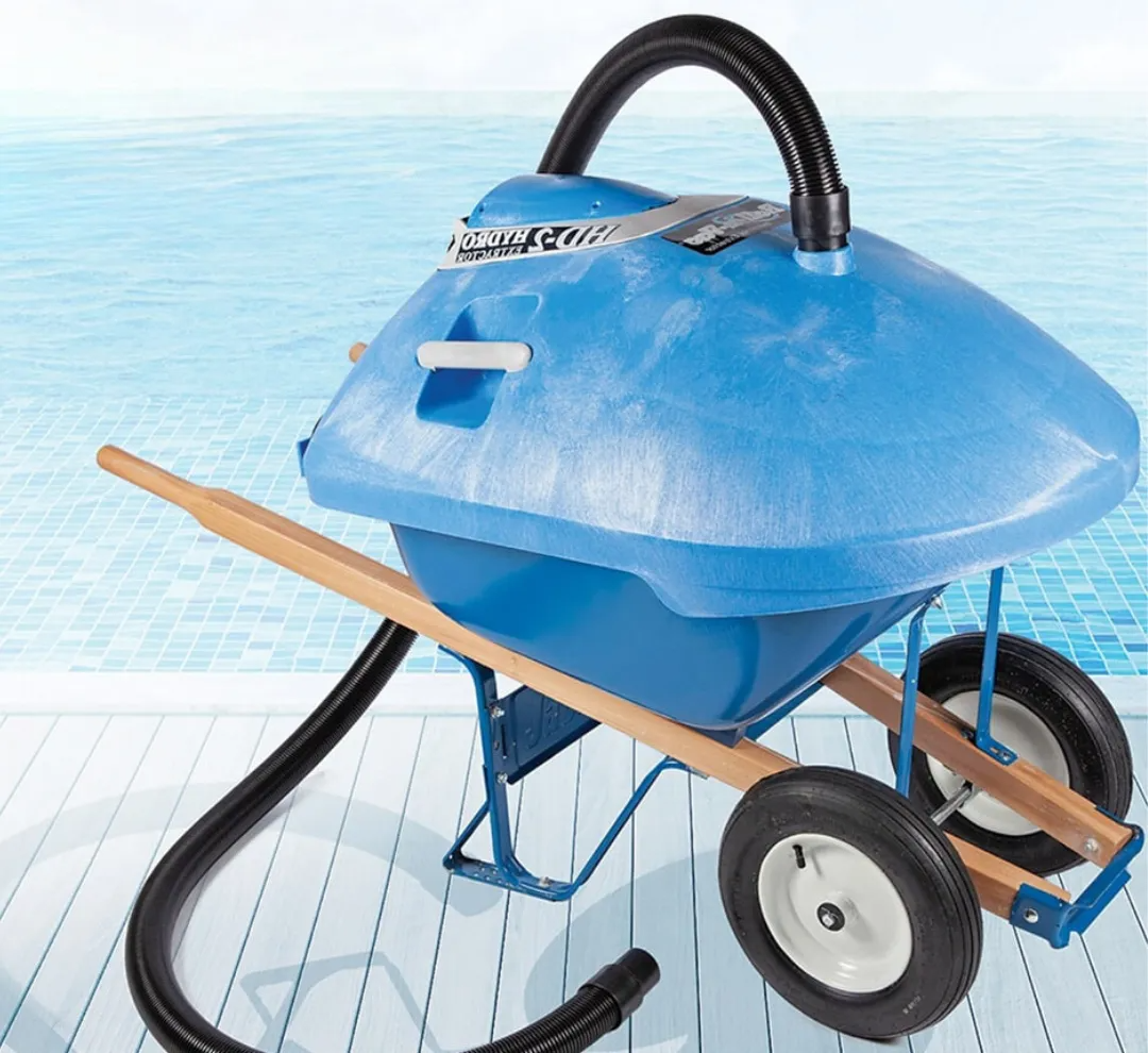 Blue robotic pool cleaner with wheels and hose on a tiled surface, against a water background