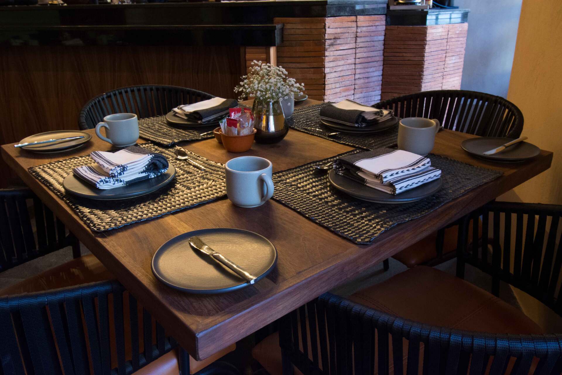 A wooden table with plates and cups on it