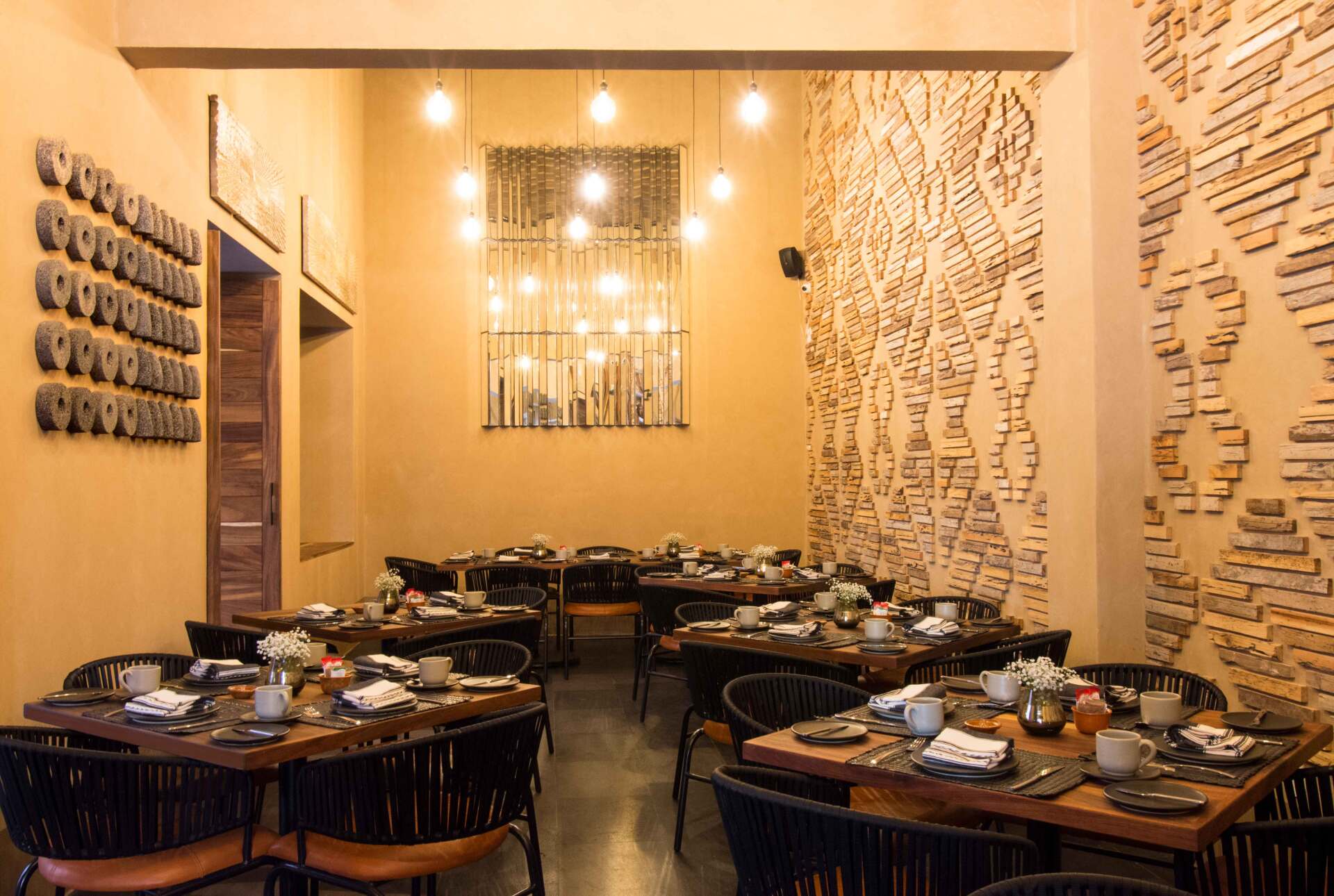 A restaurant with tables and chairs set up for a meal.