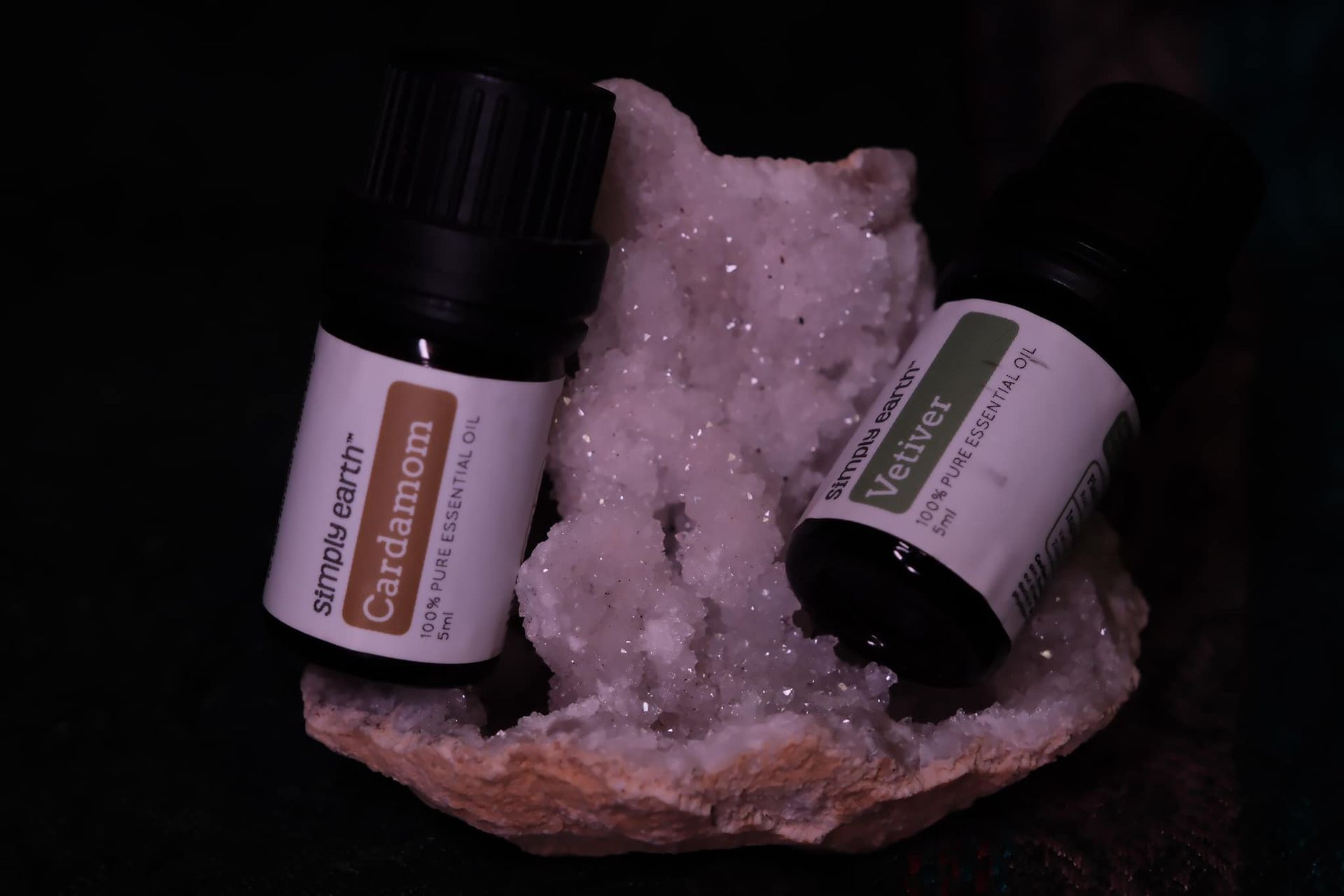 Two bottles of cardamom and vetiver essential oils