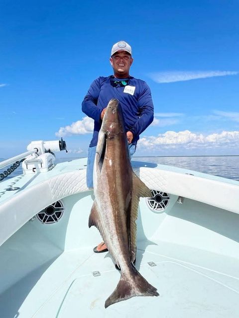 Badfish Charters captain holding a large redfish in Tampa Bay