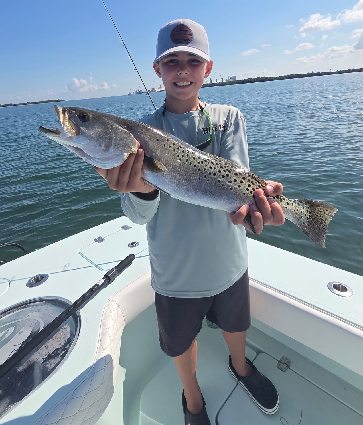 A man is holding a large red fish in his hands