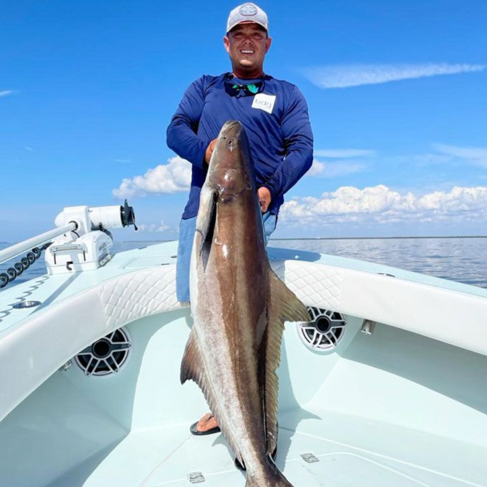 Badfish Charters captain holding a big tarpon in Tampa Bay