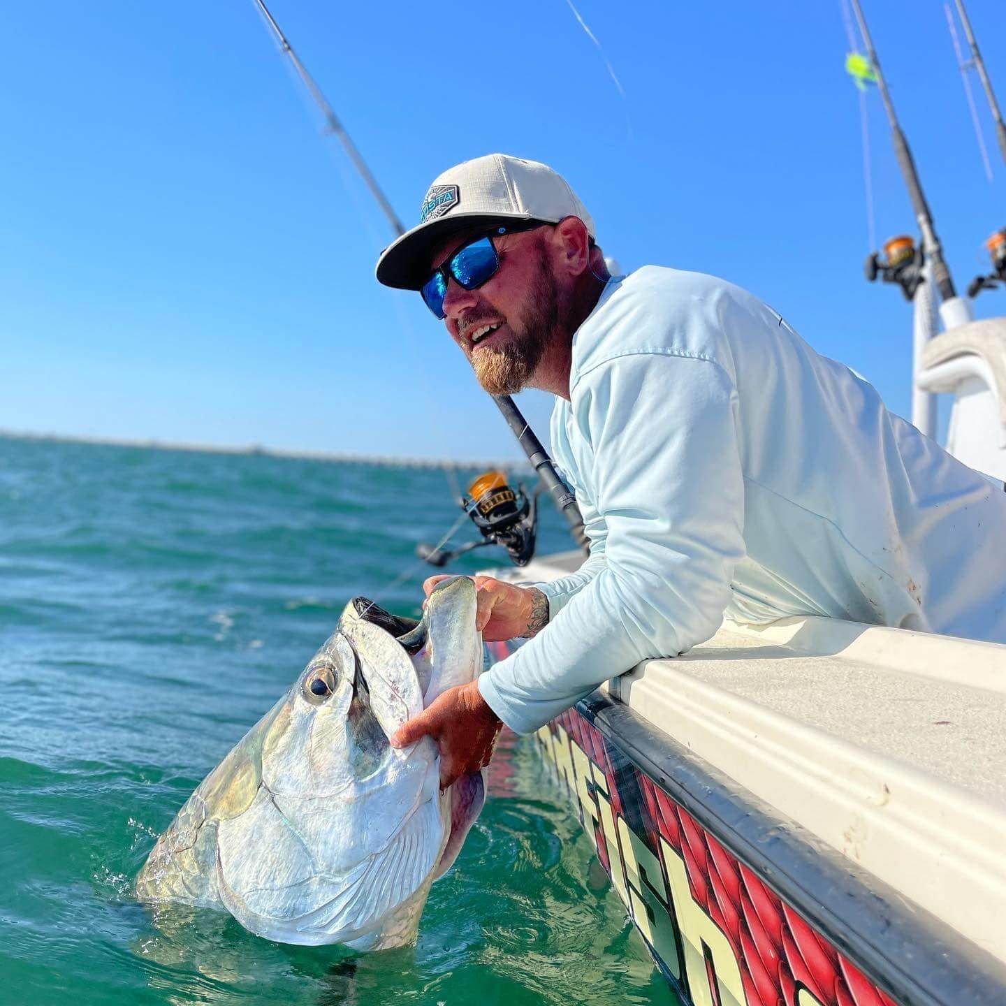 Captain William Wise of Badfish Charters holding a big Tarpon.