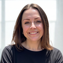 A woman in a black shirt is smiling for the camera