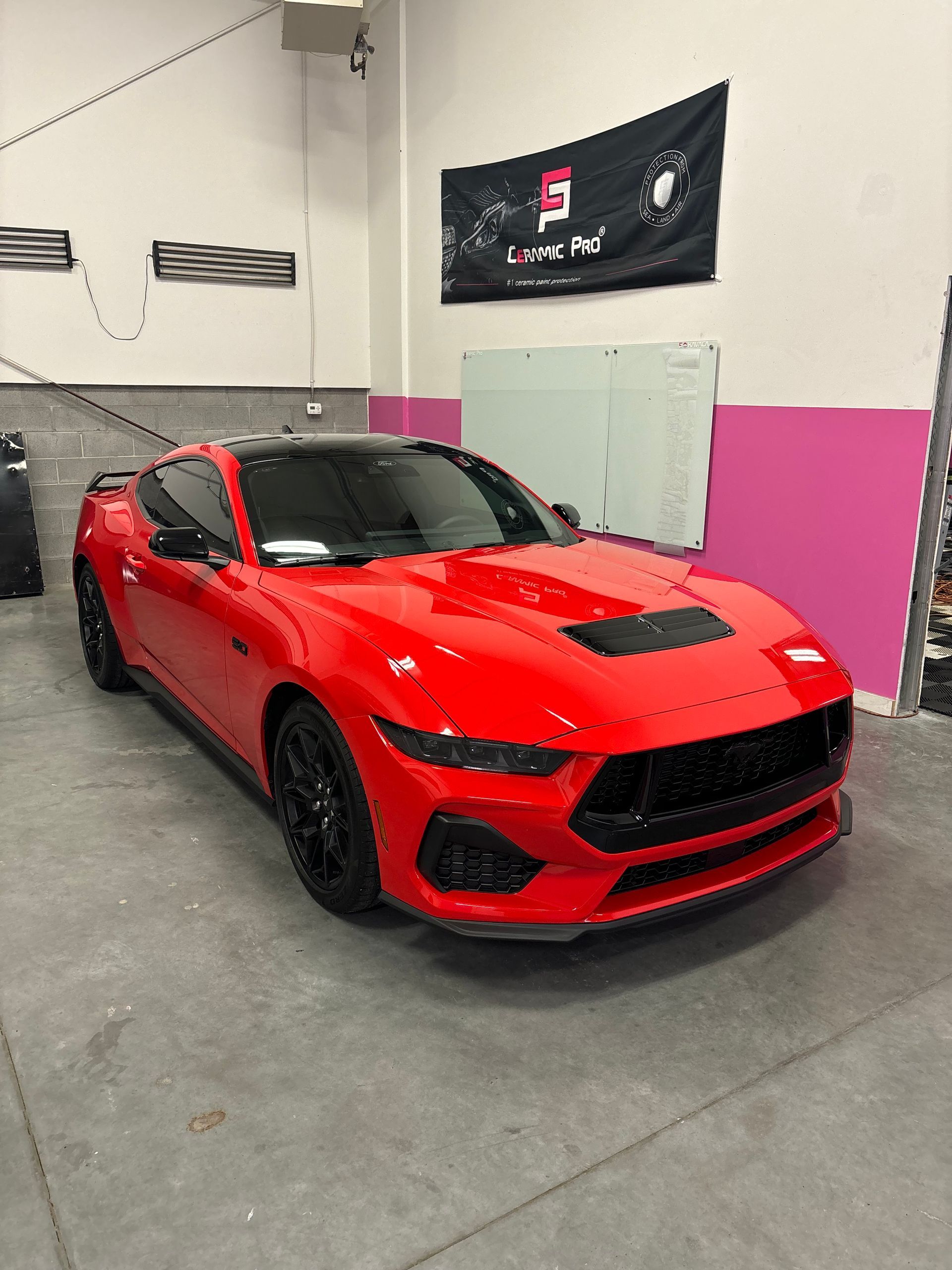 A red Ford Mustang sits at Stokes Auto Spa in Lindon after getting tinted, ceramic coated, and paint protection film installed.