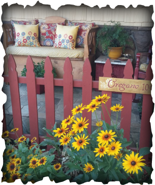 A red picket fence with a sign that says oregano 10