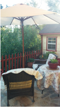 A patio with a table and chairs under an umbrella