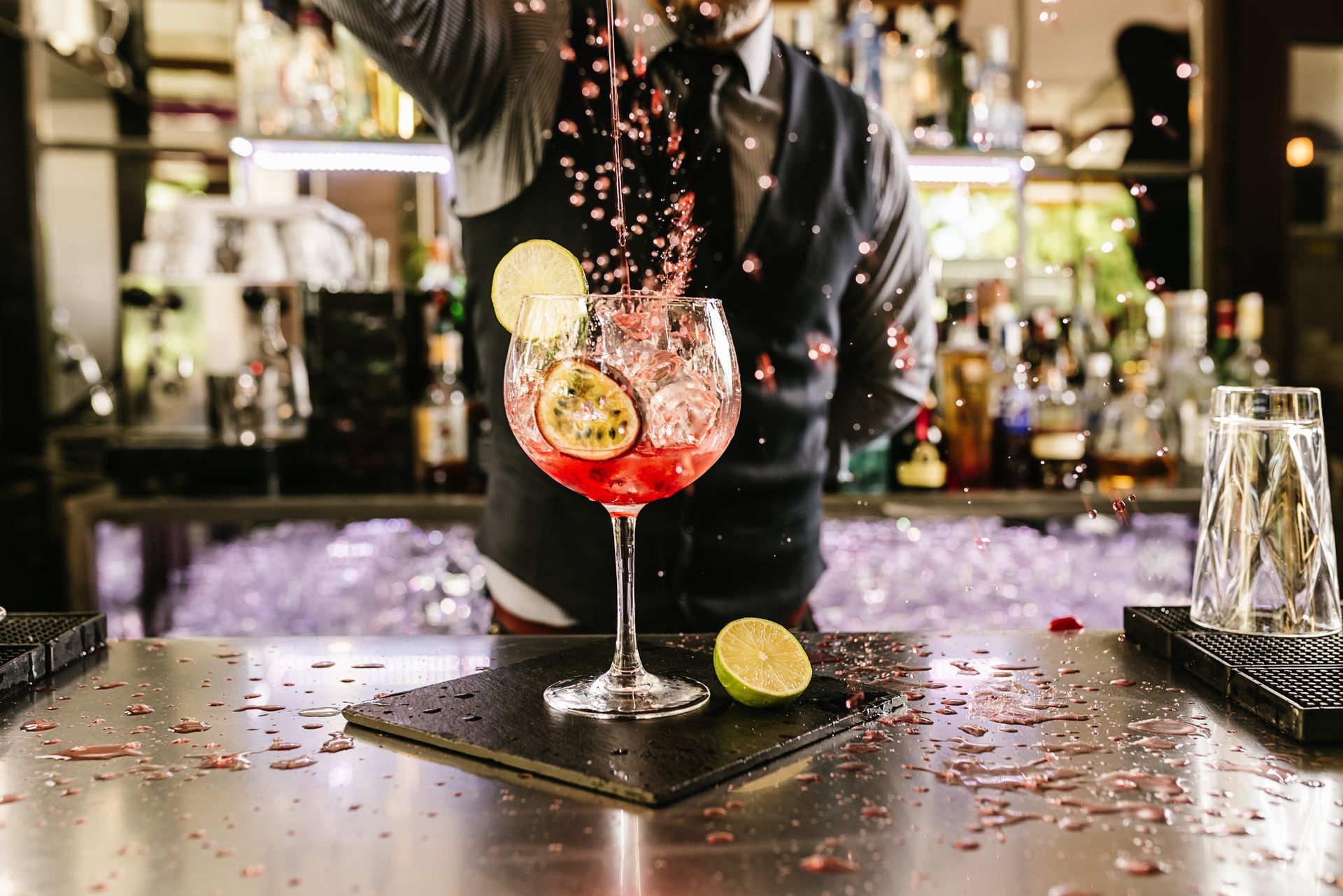 Expert barman is making cocktail at night club