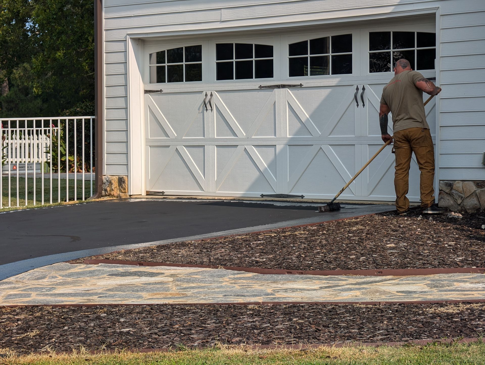 Tier One doing sealcoating an asphalt driveway