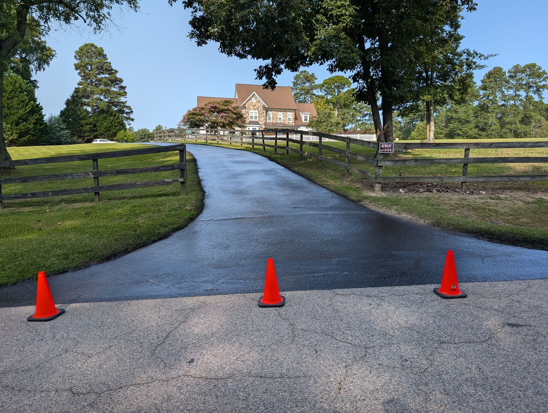 Beautiful, freshly sealcoated driveway by Tier One Asphalt & Sealcoating