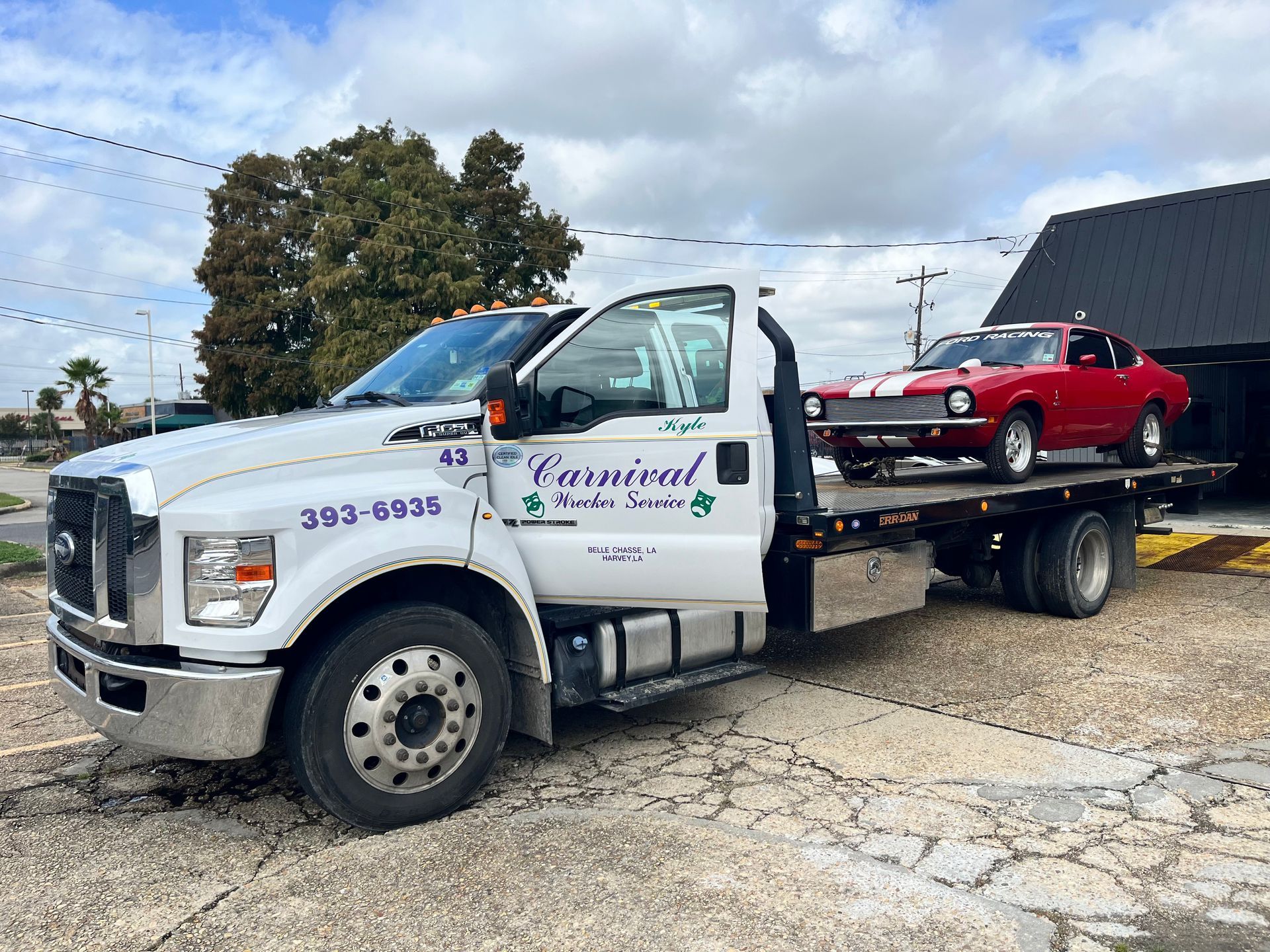 White semi truck towing a trailer across a littered indoor stadium floor