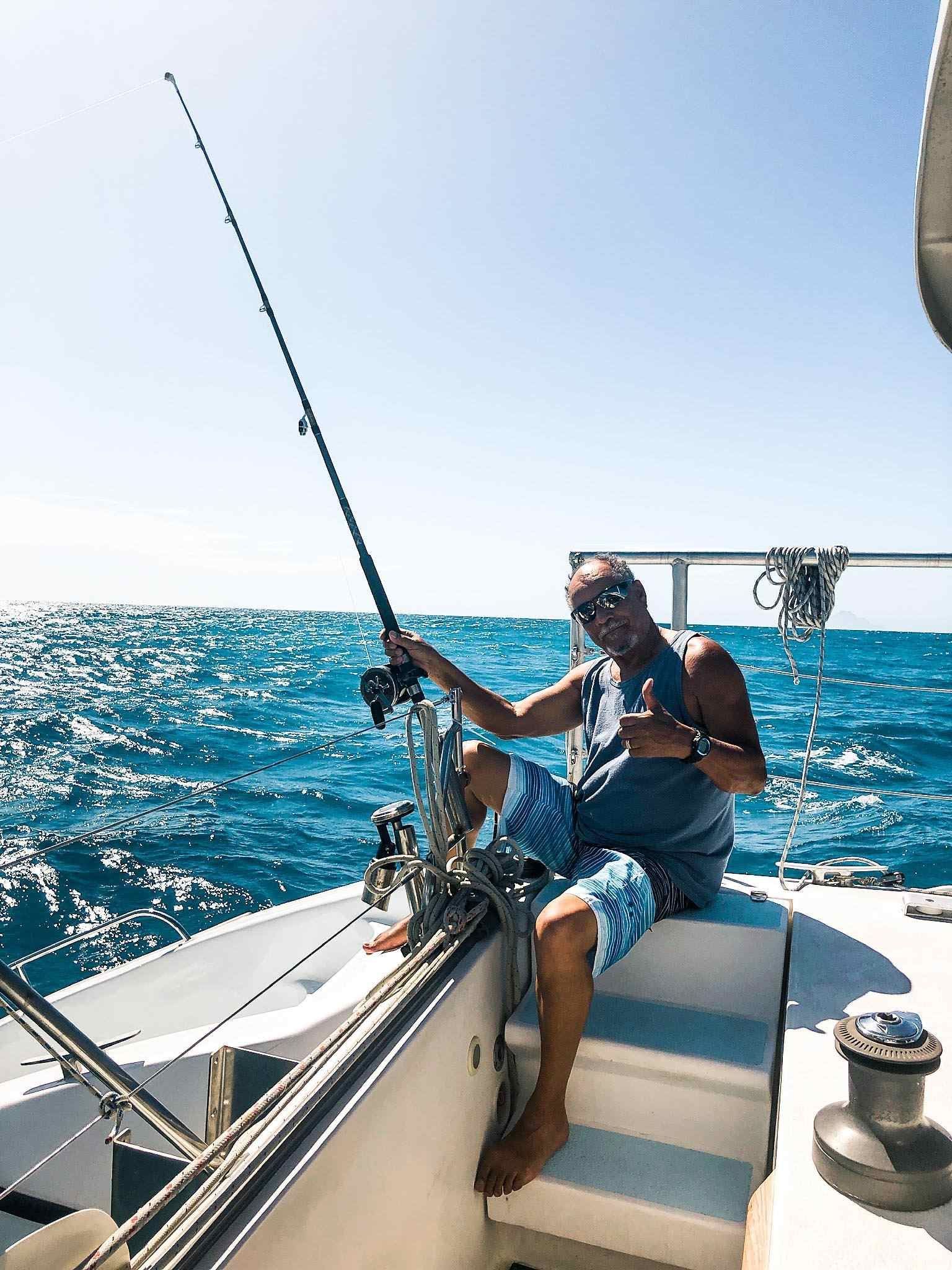 Fishing off the aft deck of the catamaran Random Wind