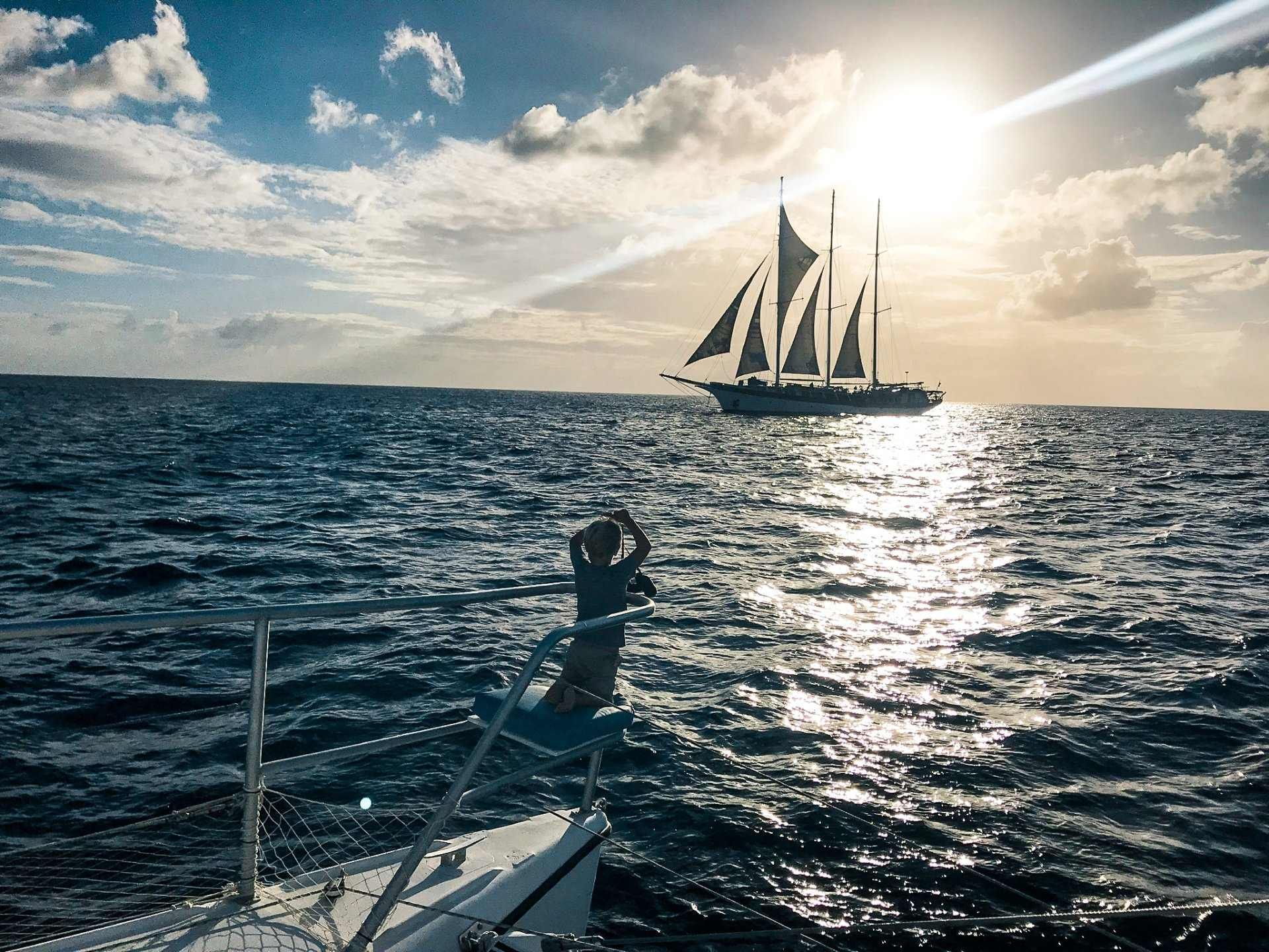 A tall ship passing SV Random Wind during sunset cruise