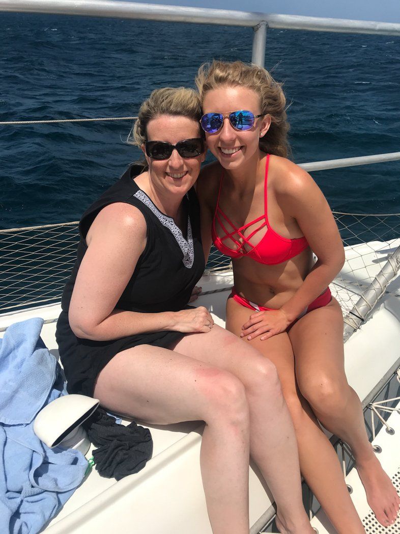two women sitting on boat smiling