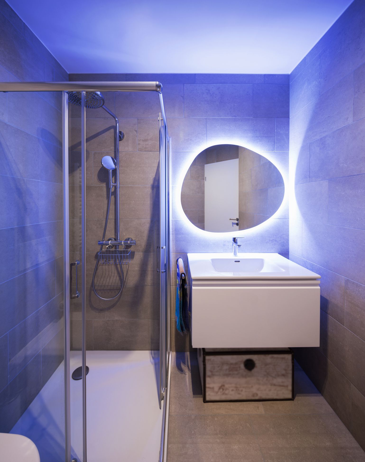 A bathroom with a sink a mirror and a shower