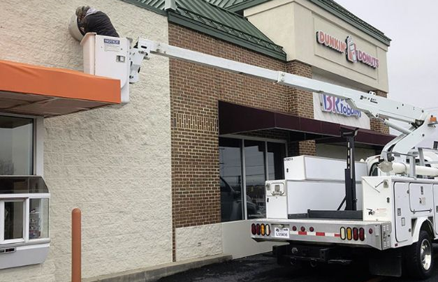 VA Commercial Utility truck parked by a shopping center entrance on a wet day - Platforms for Emergency Commercial HVAC Repair in VA