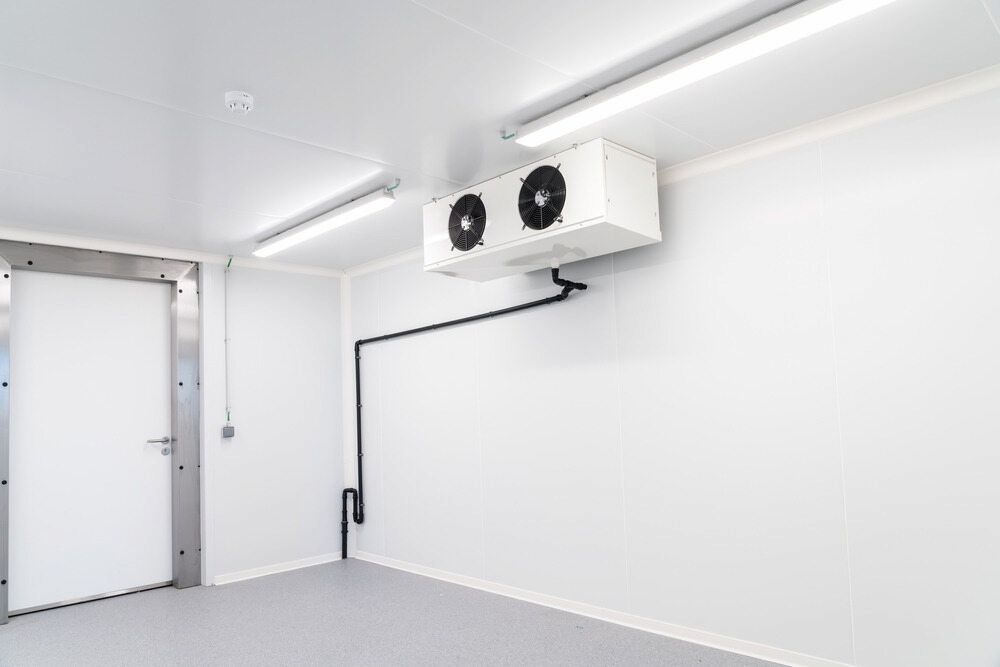An Empty Refrigerator With Stainless Steel Shelves and a Fan — Complete Airconditioning & Refrigeration in Darwin, NT