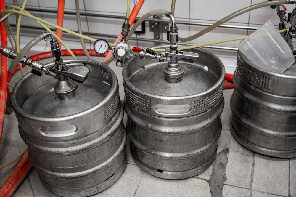 Three Stainless Steel Kegs Are Stacked — Complete Airconditioning & Refrigeration in Darwin, NT