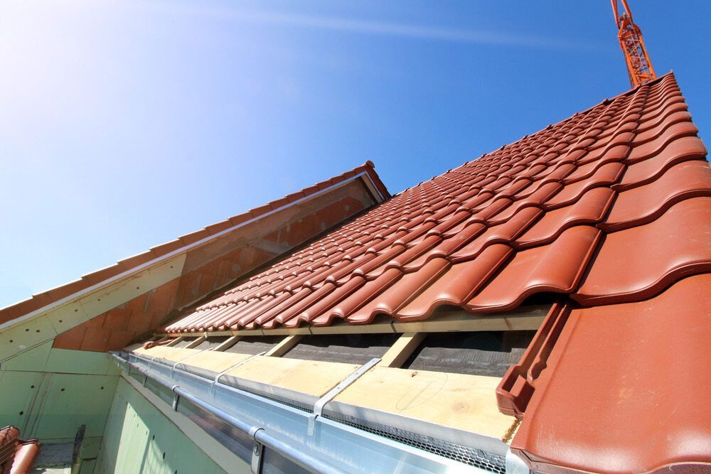 A Roof With Red Tiles is Being Built on a House — Wagga Roof Repairs In Griffith, NSW