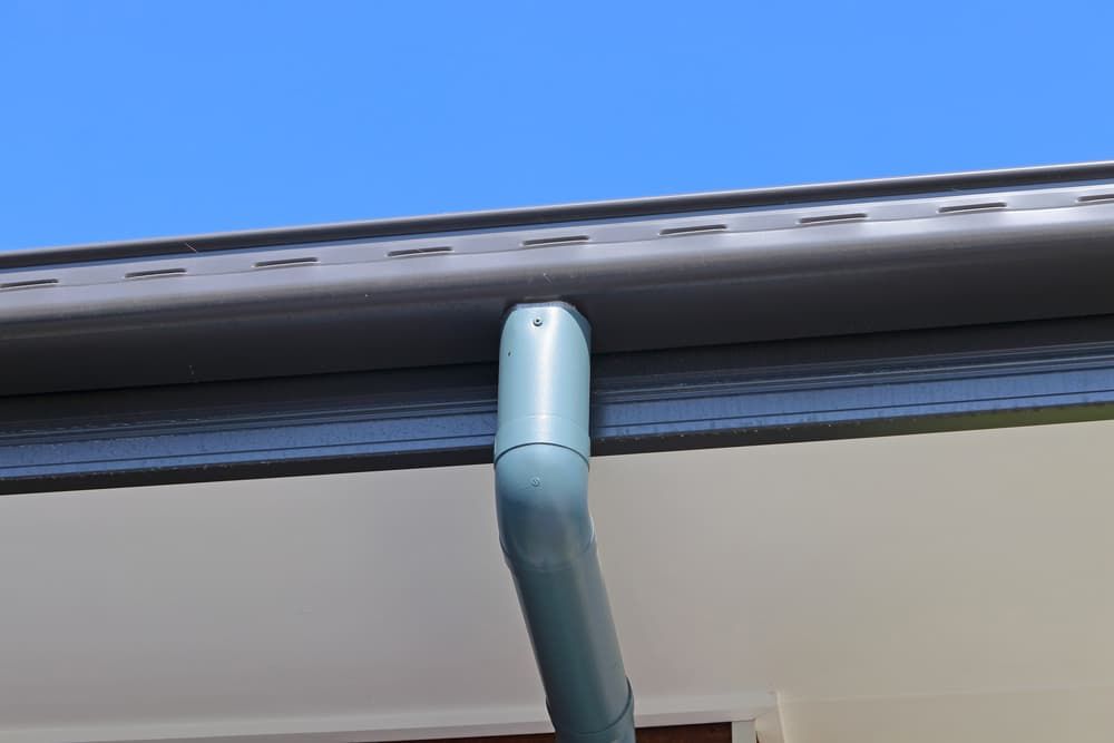 A Close Up of a Gutter on a House With a Blue Sky in the Background — Wagga Roof Repairs In Tumut, NSW