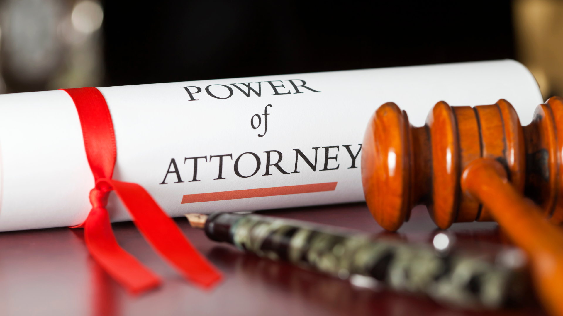 A power of attorney is sitting on a table next to a gavel.