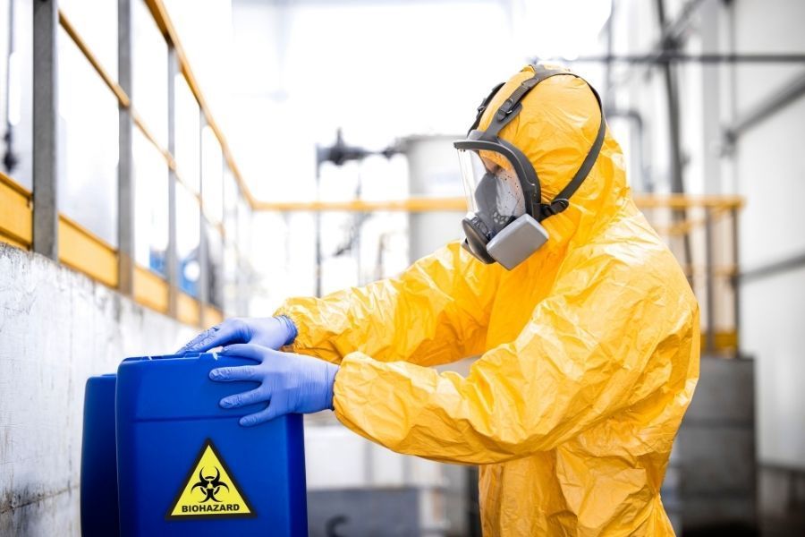 Biohazard cleanup technicians wearing full personal protective equipment during a residential remediation job