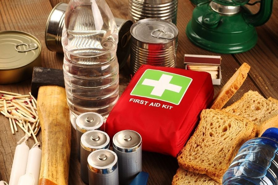 Essential items for a storm emergency kit laid out and ready to pack