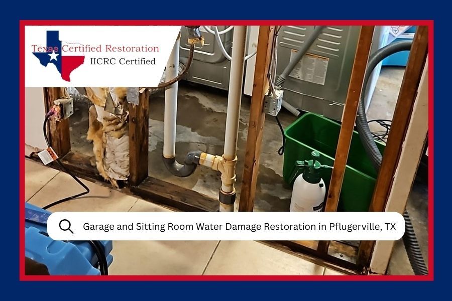 A construction site showing water damage restoration progress in a room with exposed wall studs and plumbing.