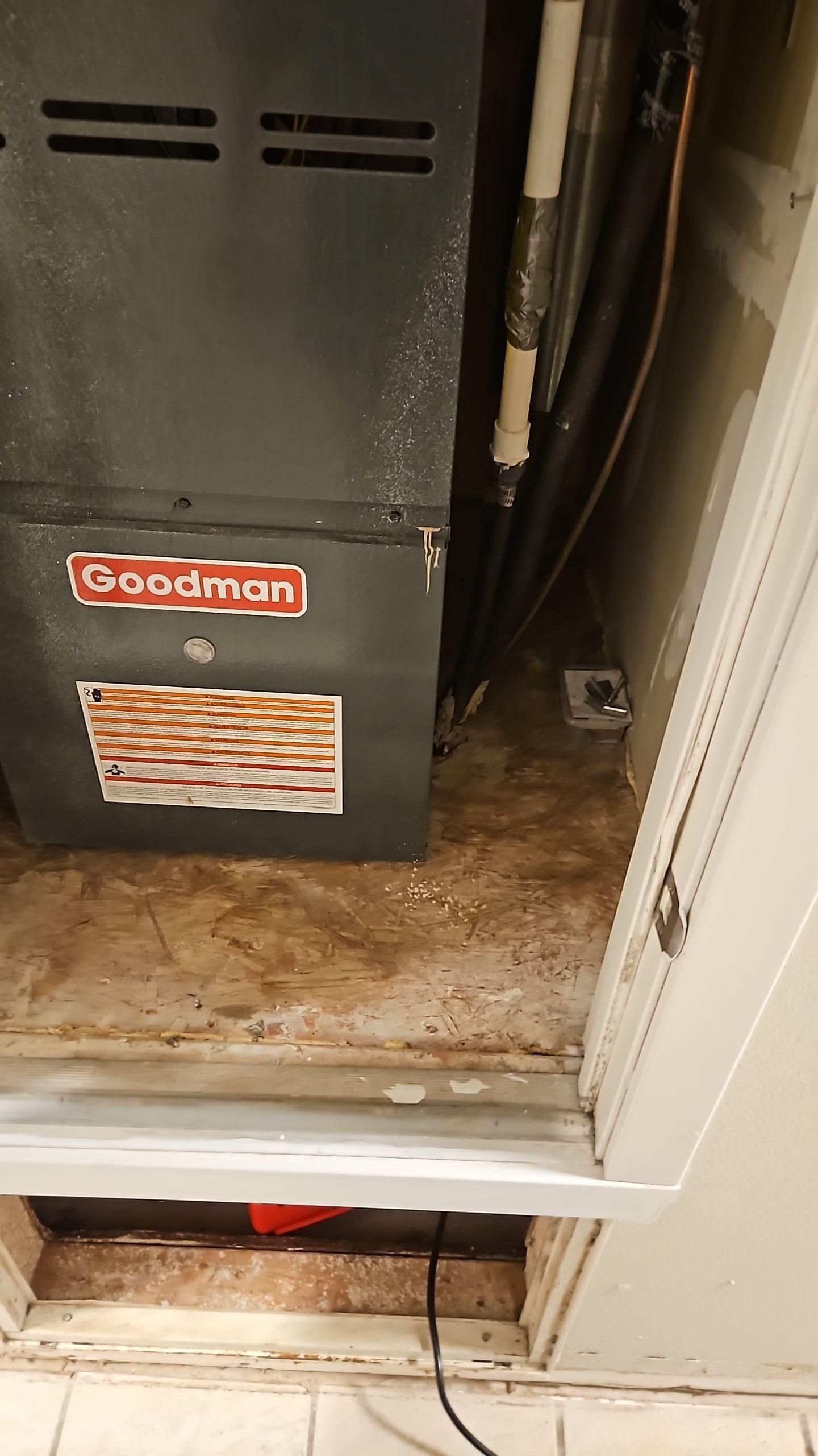 AC closet with visible water damage on walls and floor