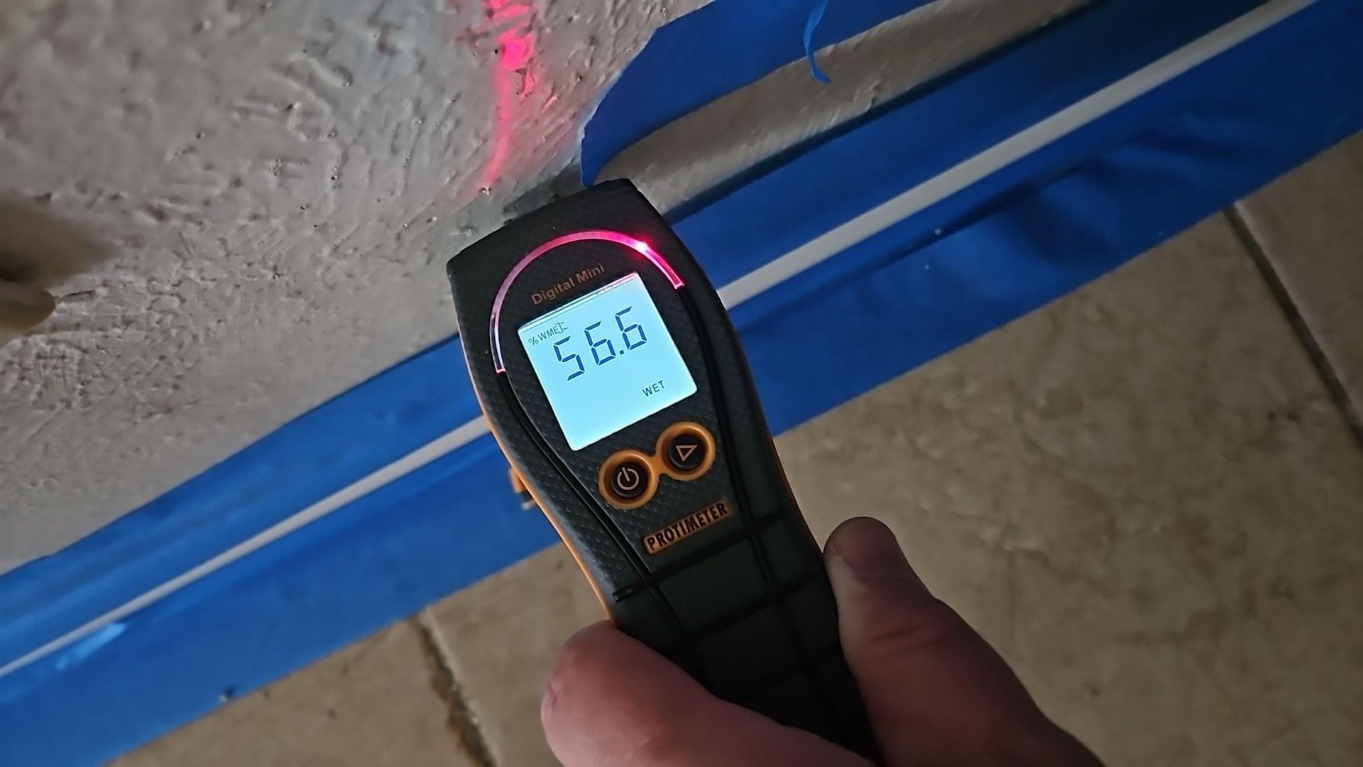 Close-up inspection of broken pipe damage inside garage wall cavity