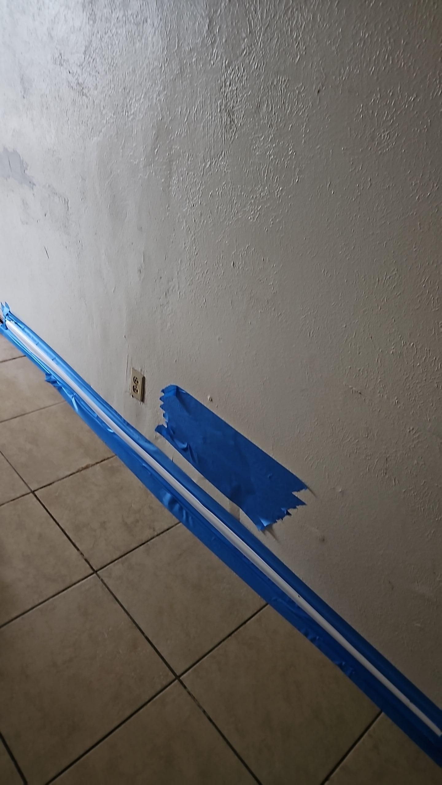 Broken pipe water damage inspection showing moisture behind garage wall