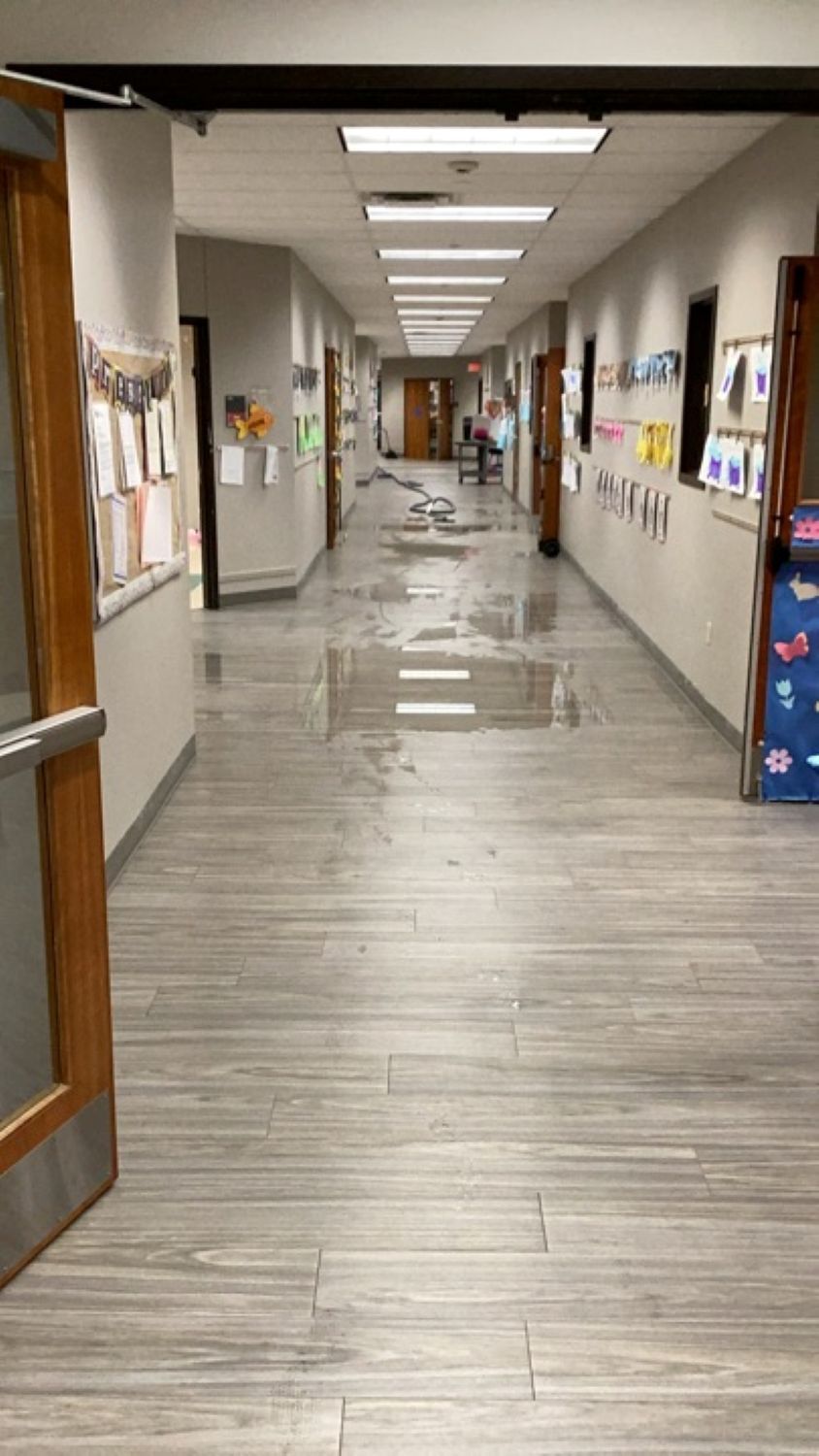 Standing water on kitchen floor during commercial water damage assessment at Austin church