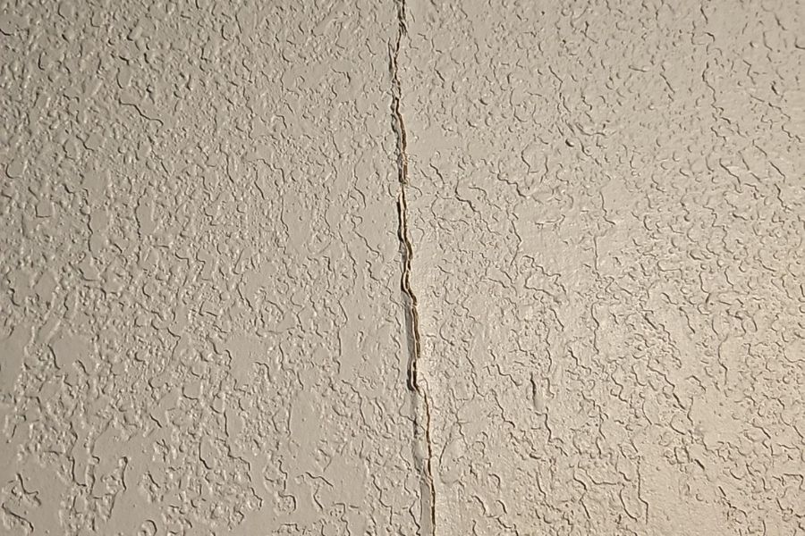 Cracked interior wall showing storm damage in a Pflugerville home