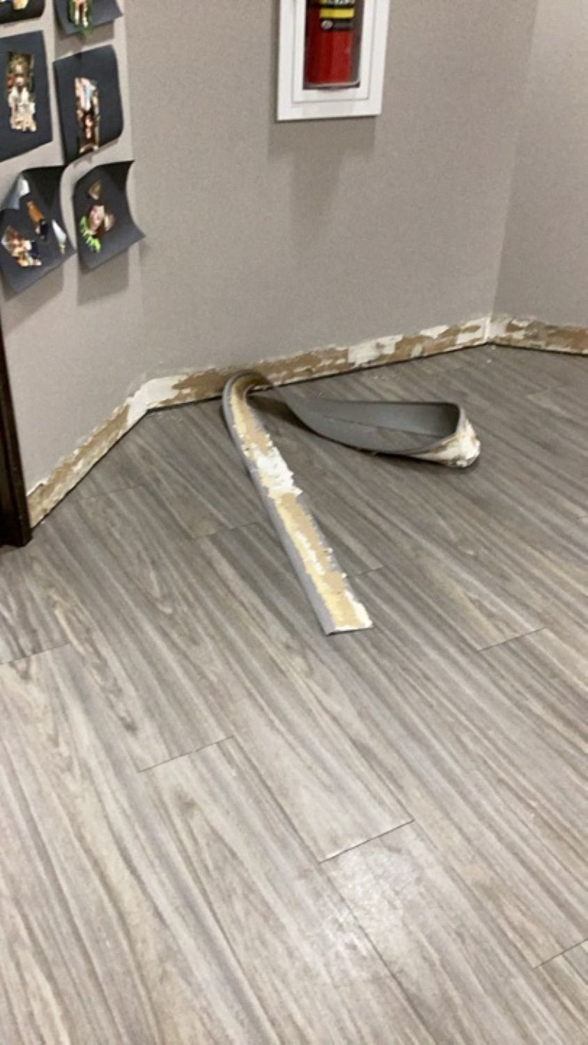 Extraction hose running into church classroom during water removal