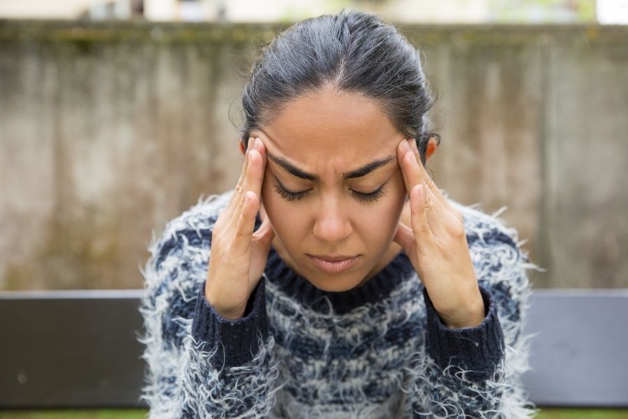 Person with headache from smoke exposure