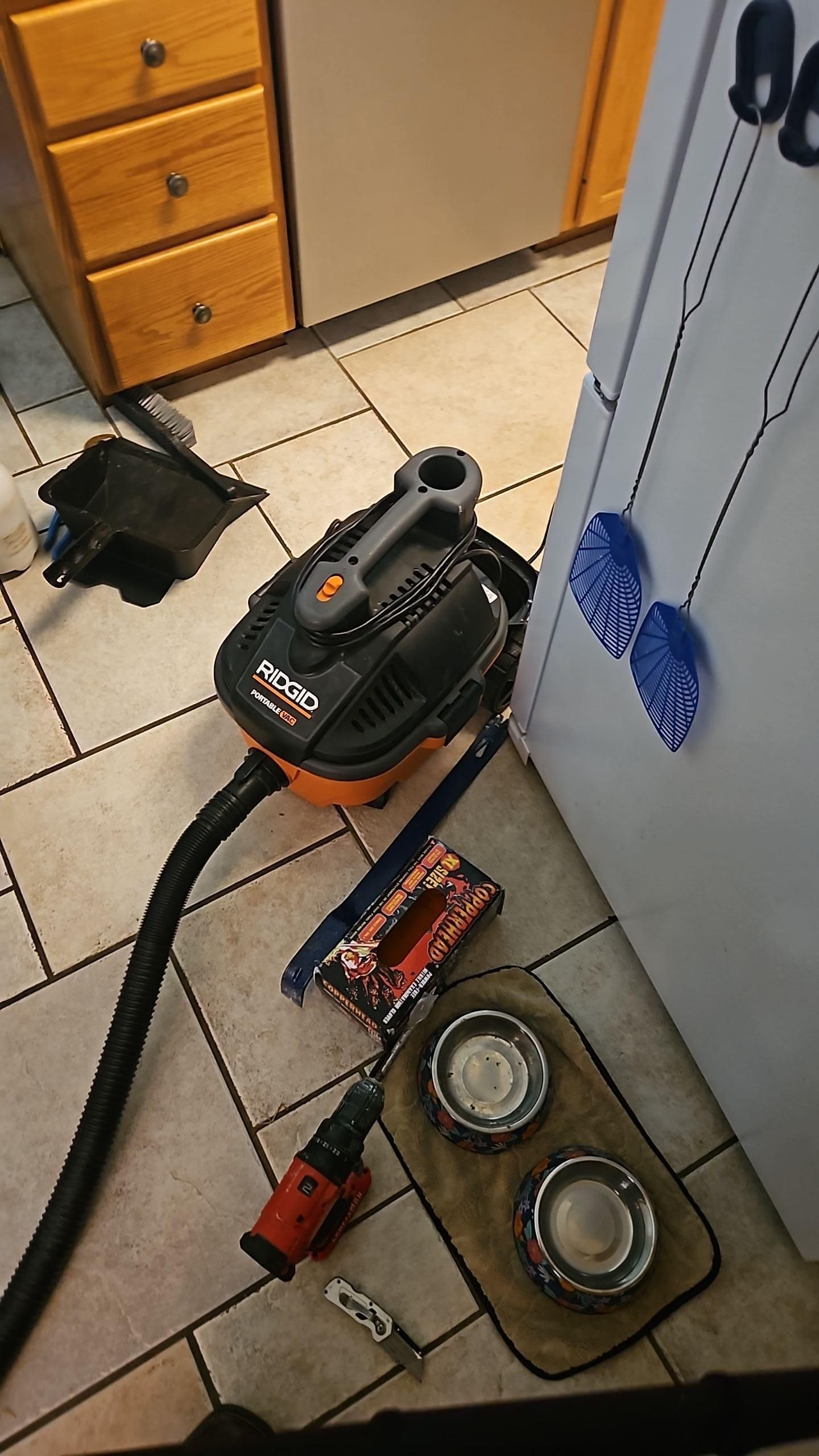 Air mover and dehumidifier setup in kitchen during water damage restoration drying process
