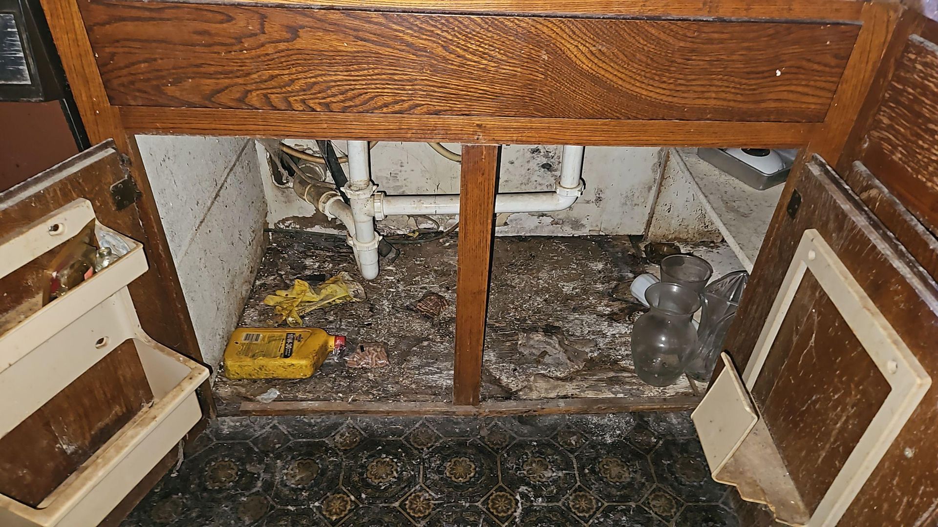 Bathroom tile removal exposing mold growth behind wall tile during Pflugerville remediation job