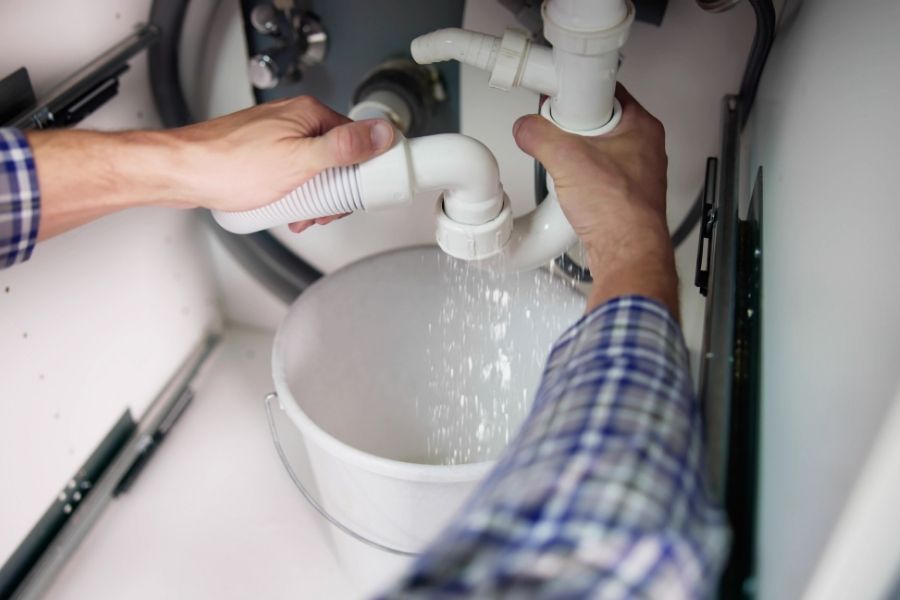 Under-sink supply lines showing braided flexible hoses, a common source of hidden slow water leaks in Austin-area homes