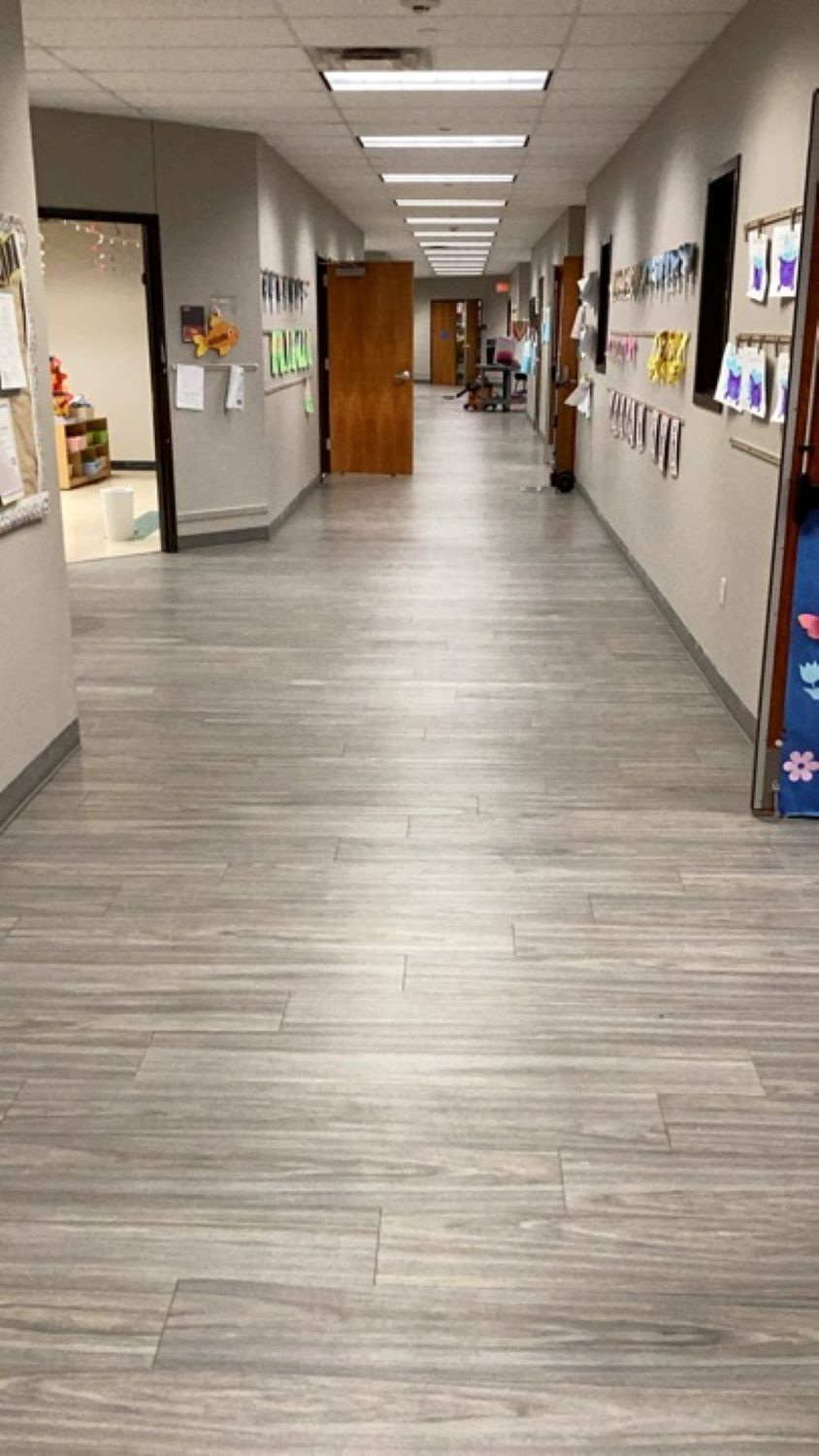 Restored church hallway with clean dry floors and children's artwork on walls