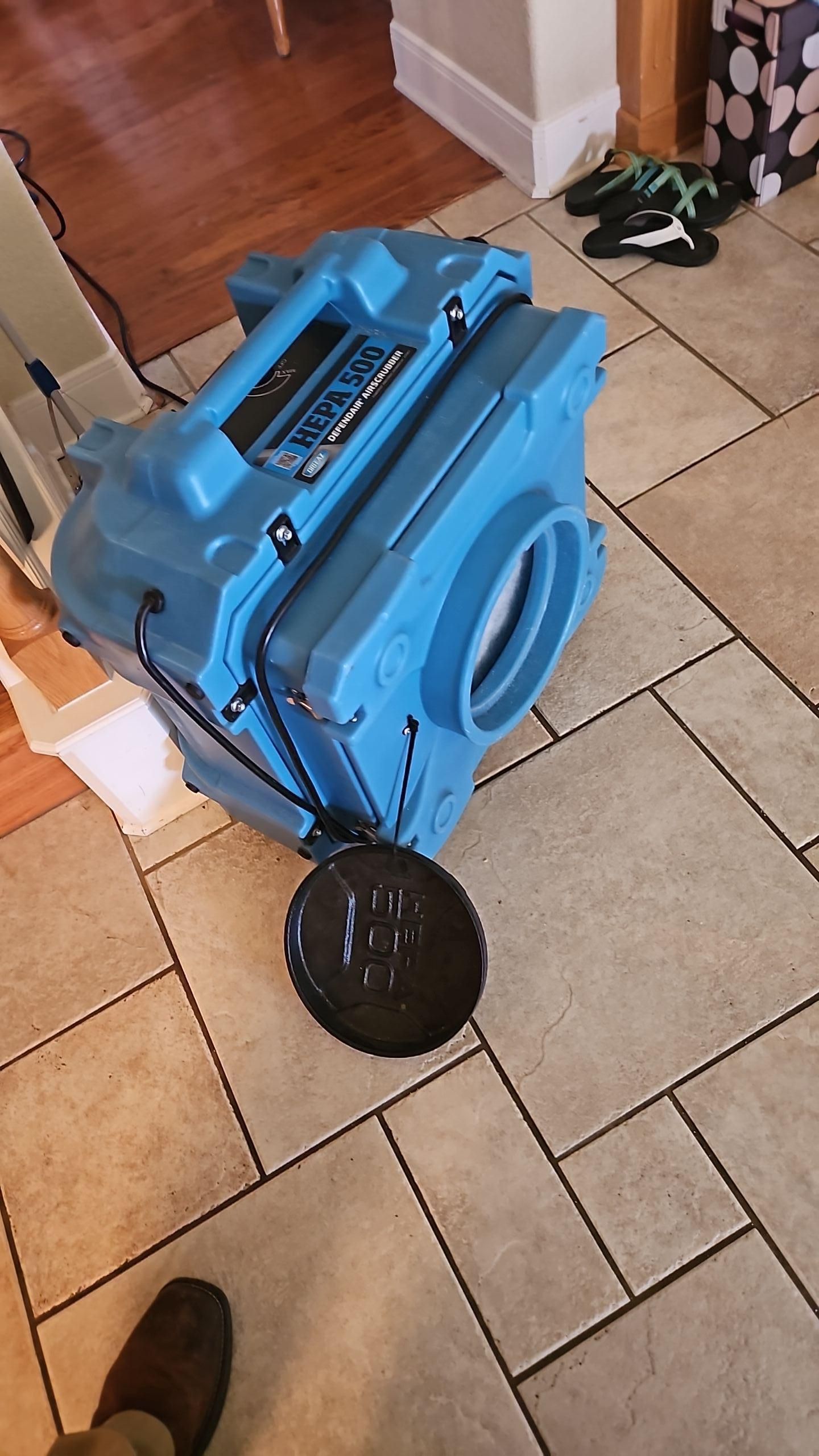 Water damage mitigation equipment operating across multiple rooms to dry out affected areas