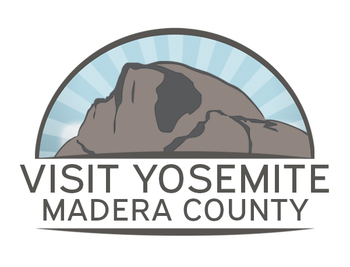 Logo for Visit Yosemite Madera County. Shows a gray mountain outline against a blue, sunburst sky. Text below.
