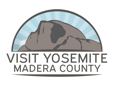 Logo for Visit Yosemite Madera County. Shows a gray mountain outline against a blue, sunburst sky. Text below.