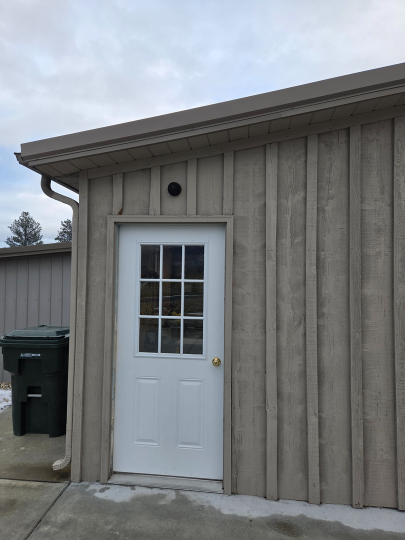 Outdoor security camera installed above entry door in Hamilton Montana — Smart Home Solutions