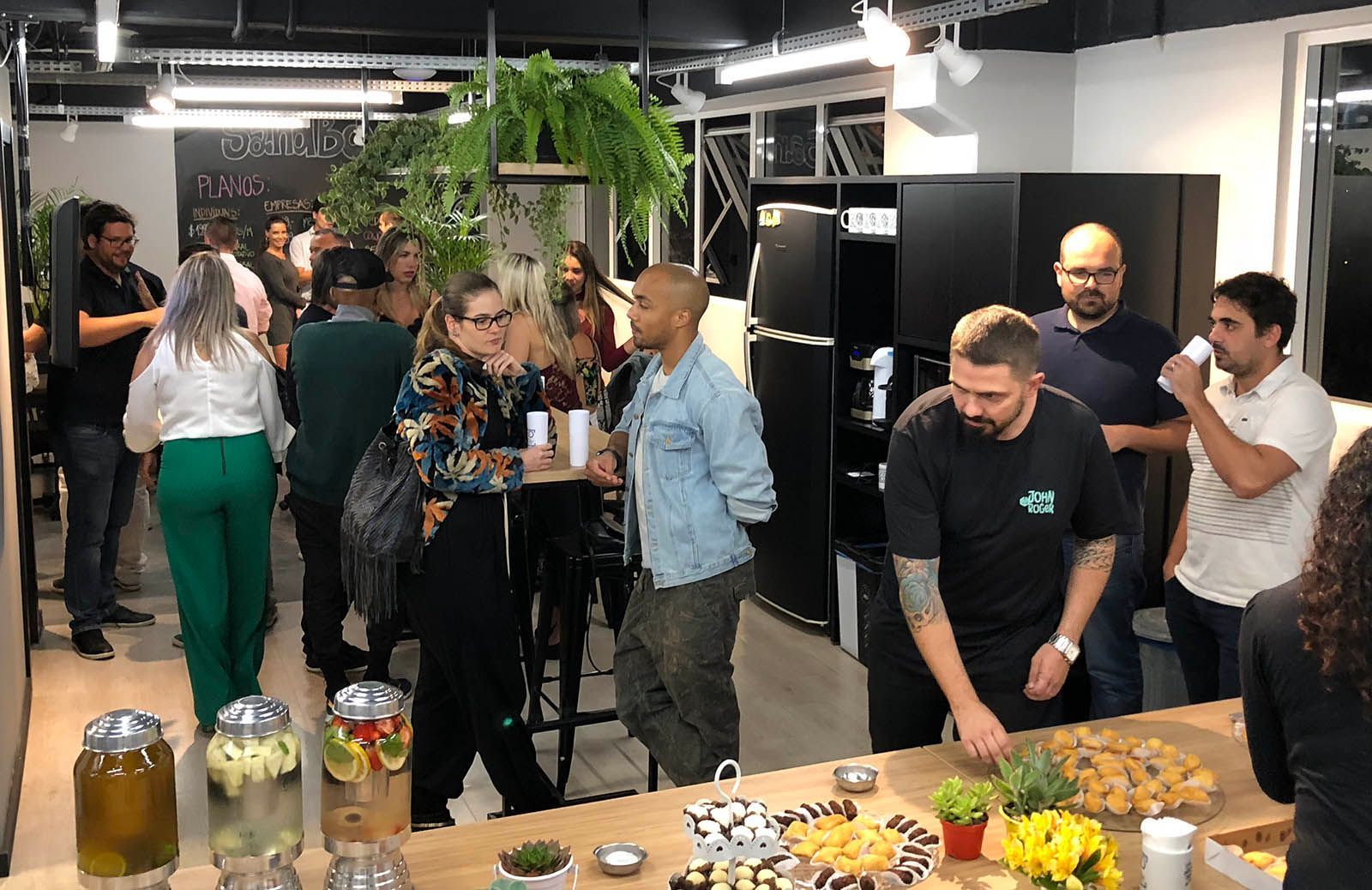 A group of people are standing around a table in a room.