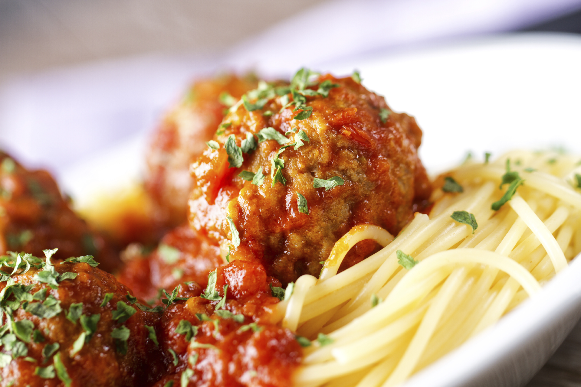 A kid-sized portion of spaghetti and meatball in marinara sauce, perfect for little ones to enjoy.