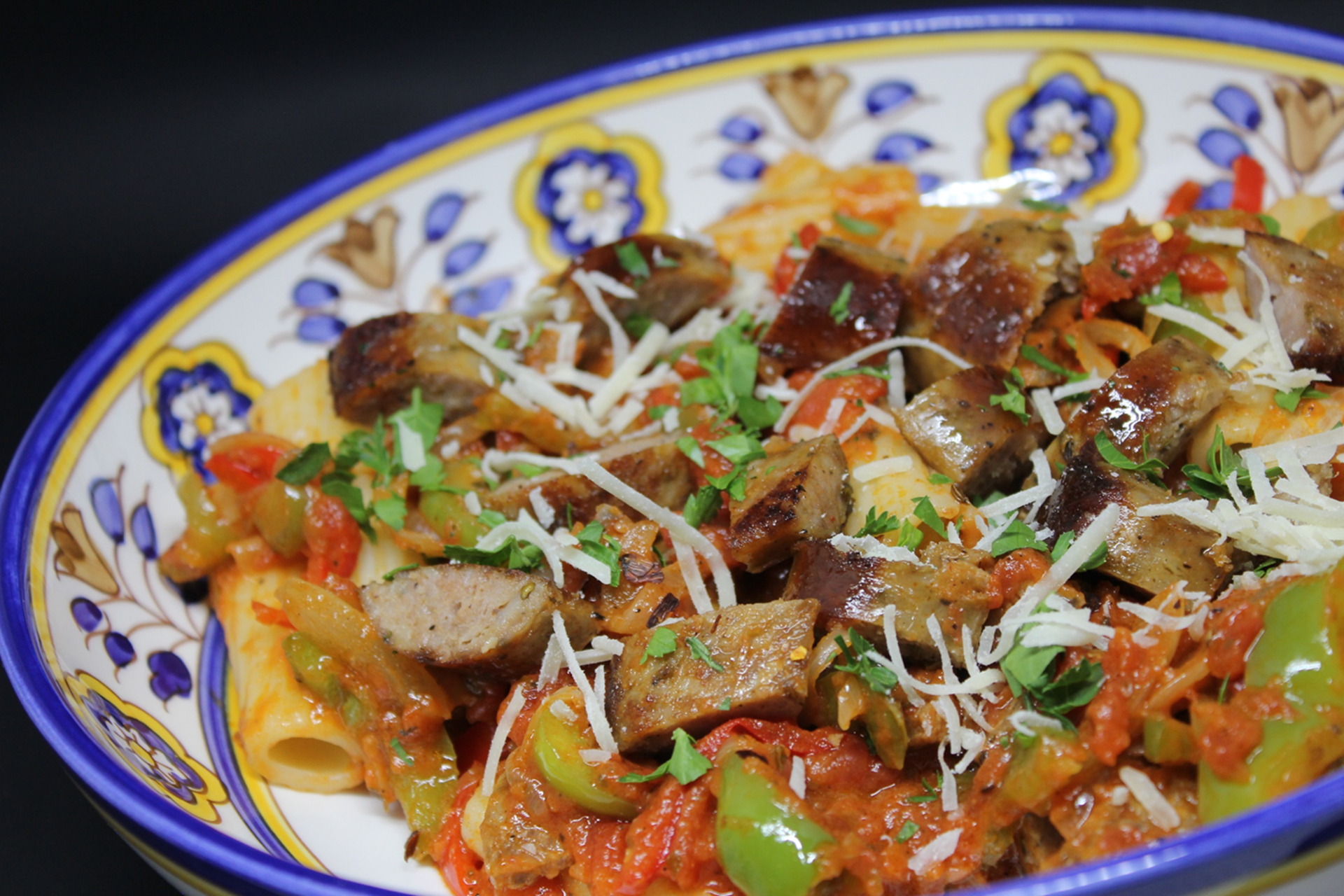A hearty Italian stew of diced veal, sausage, potatoes, onions, and green peppers simmered in marinara sauce, served over a bed of penne pasta.
