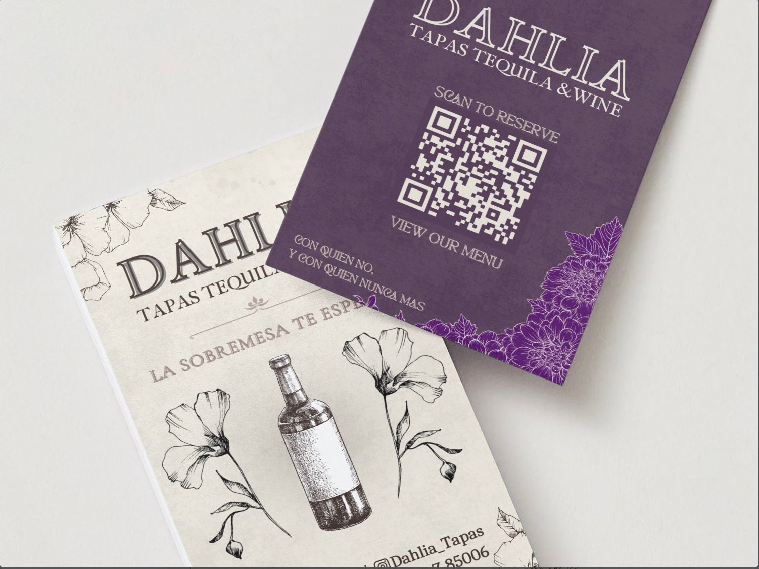 Two Dahlia Tapa Toluina wine labels, one cream and one purple with floral designs and a QR code