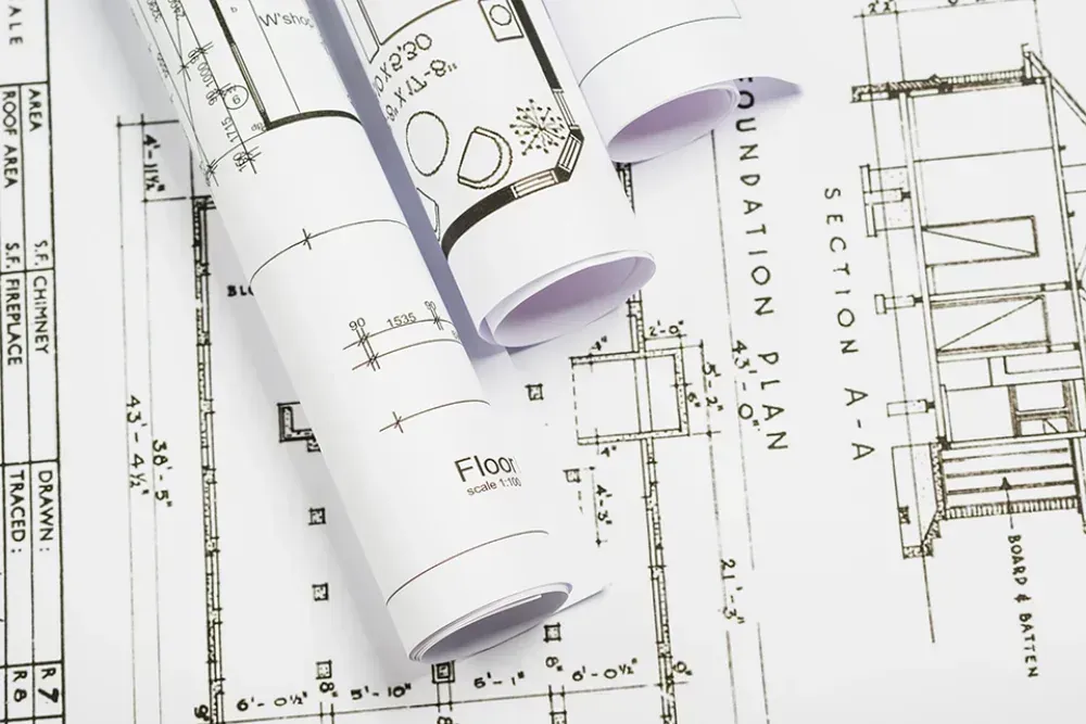 Printed architectural plans and rolled blueprint sheets