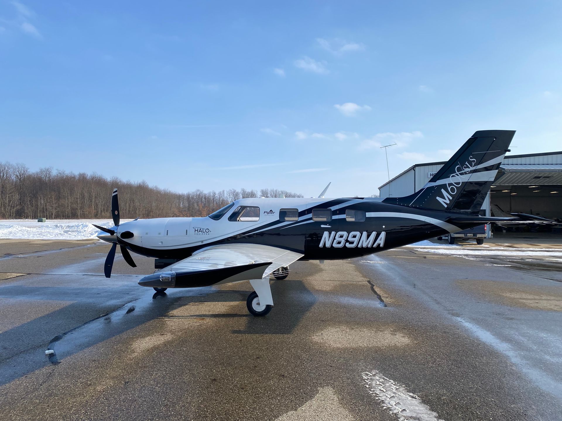 aircraft by hanger in winter N89MA